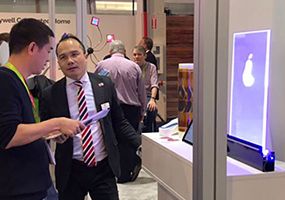 CEO Luat Nguyen talking to a visitor at iL booth