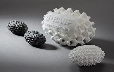 structured 3D printed objects with BASF logo, shaped as footballs