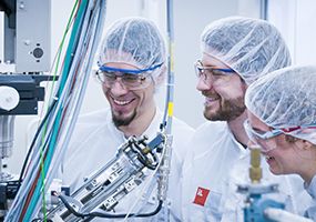 Scientists laughing in clean room labs